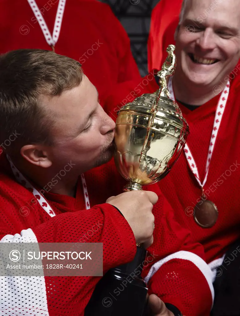 Hockey Player Kissing Trophy   