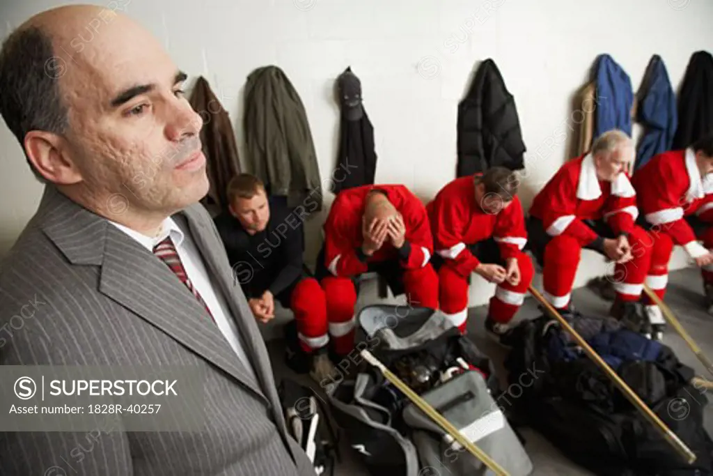 Coach and Hockey Players in Dressing Room   