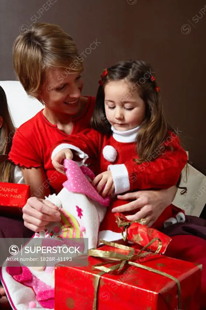 Mother and Daughter Opening Christmas Stocking   