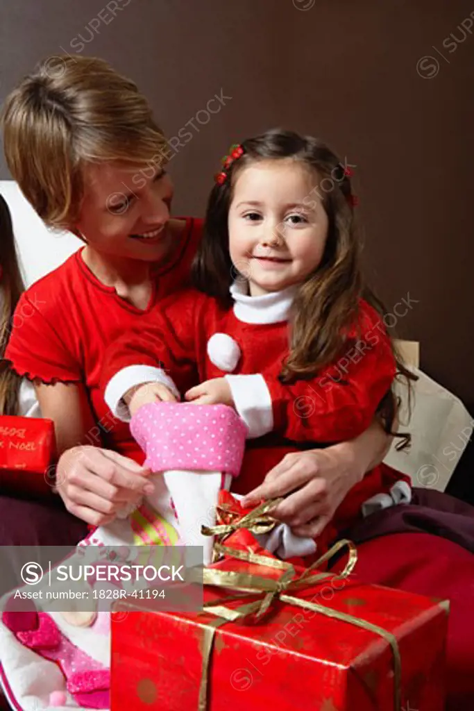 Mother and Daughter Opening Christmas Stocking   