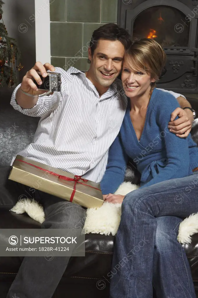 Couple Taking Photo of Themselves at Christmas   