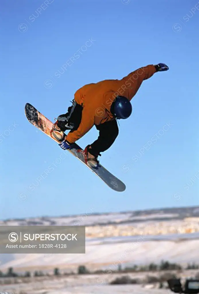 Snowboarder Jumping in Air Canadian Rockies, Alberta, Canada   
