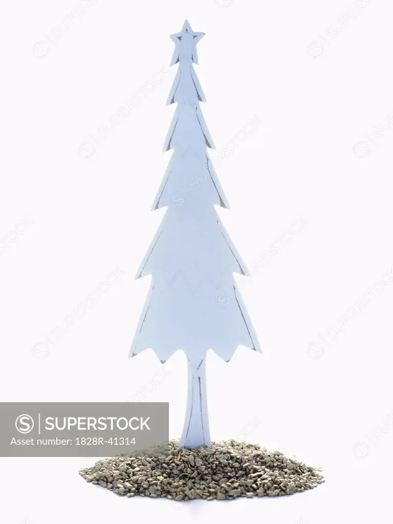 Wooden Christmas Tree Standing in Pile of Golden Rocks   