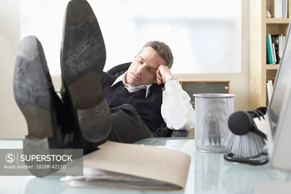 Businessman Asleep at Desk   