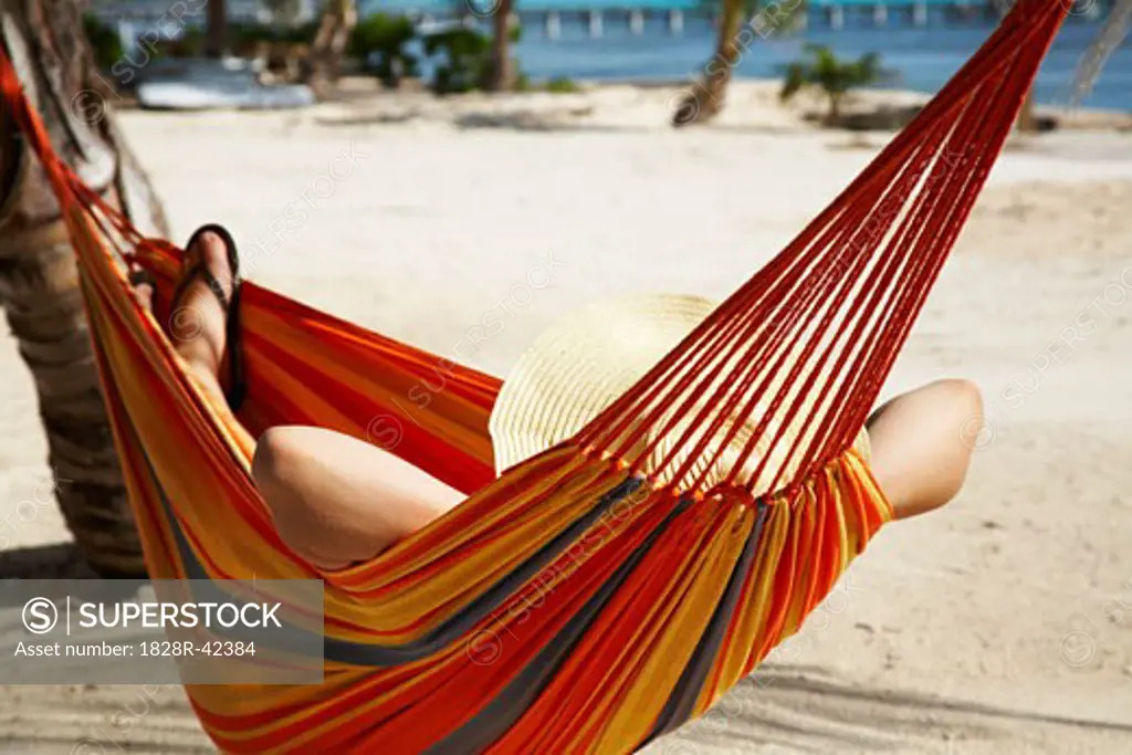 Woman Lying in Hammock on Beach   