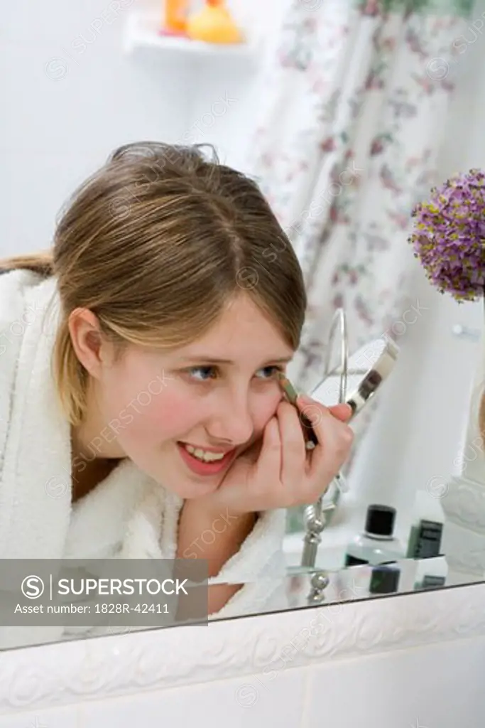 Teenage Girl Applying Eyeliner   