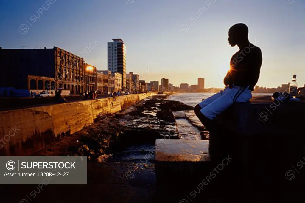 Man Sitting by Water at Sunset Malicon, Havana, Cuba   