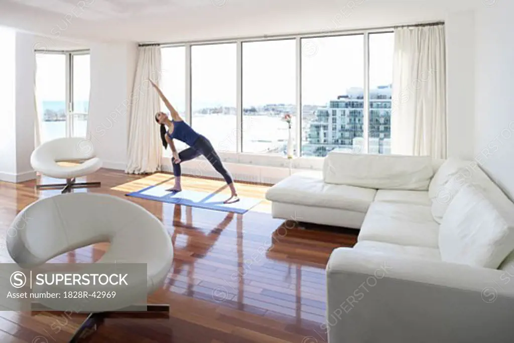 Woman Practicing Yoga in Condominium   