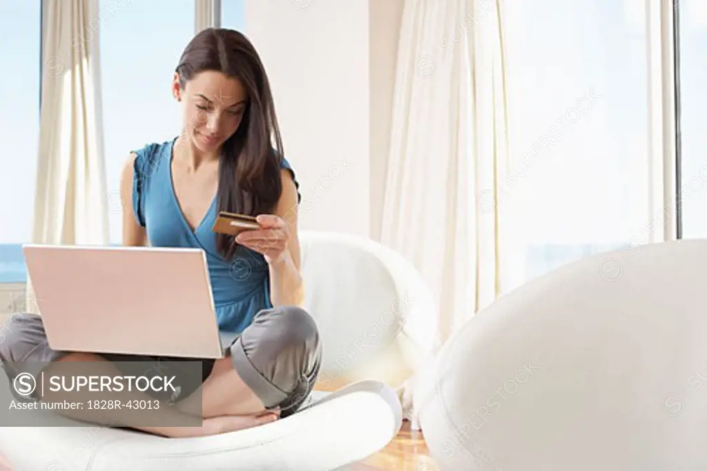Woman with Laptop Computer in Condominium   