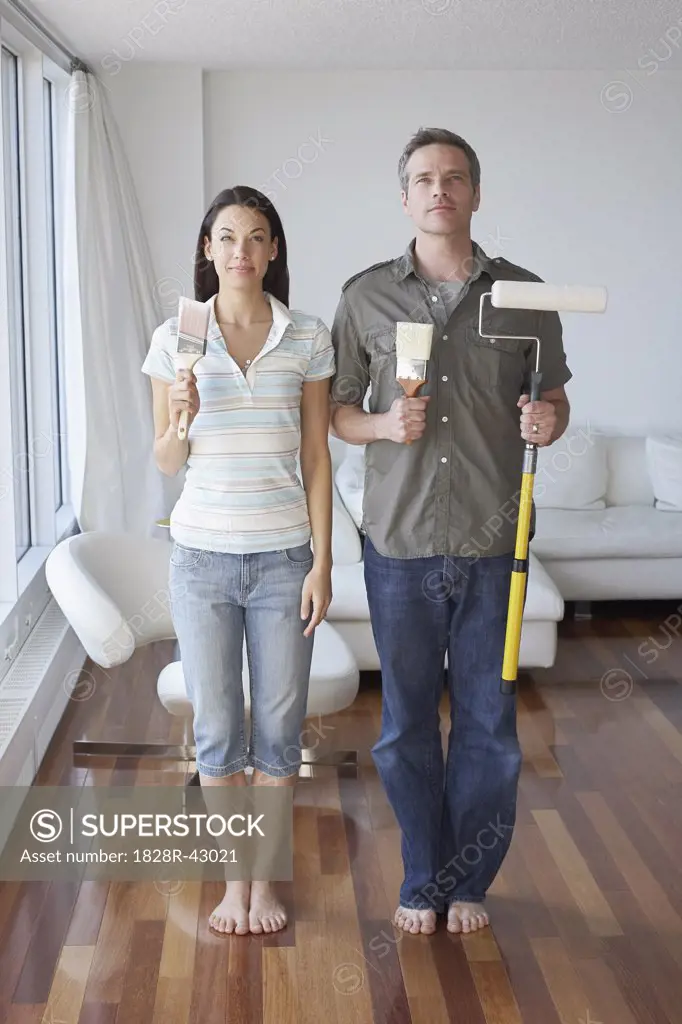 Couple in Apartment with Painting Supplies   