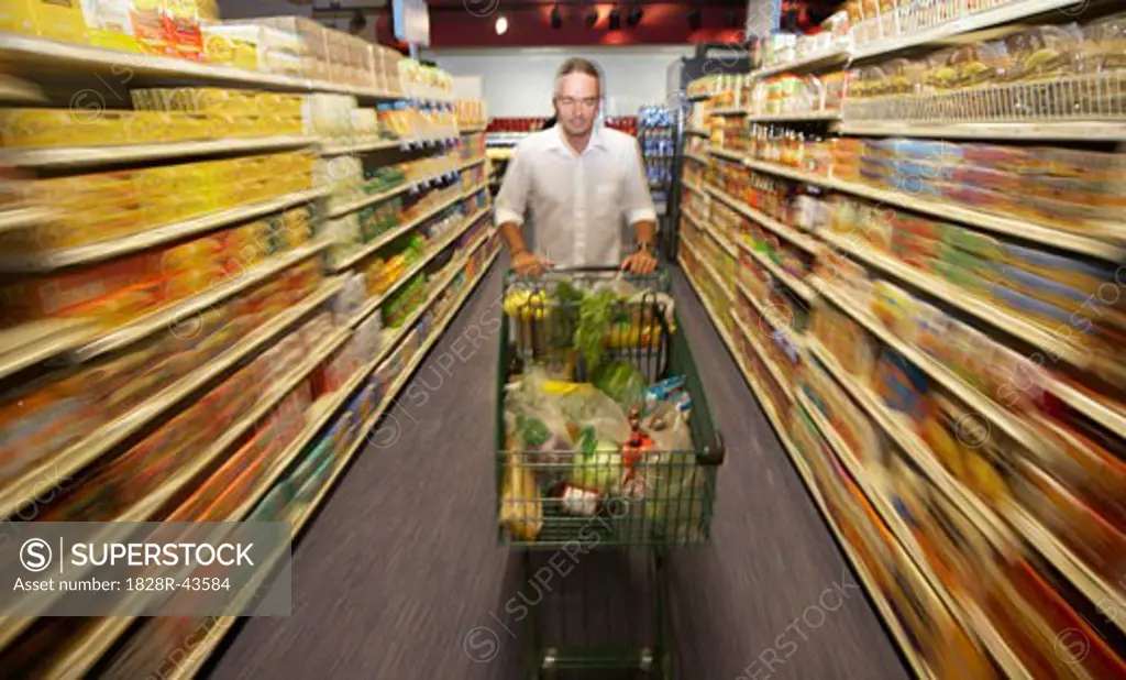 Man Pushing Grocery Cart in Store   