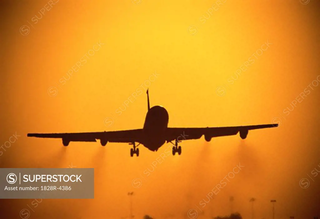 Airplane Taking Off at Sunset   