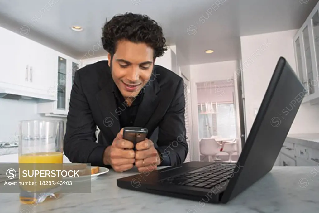 Businessman at Home, Reading Text Message   