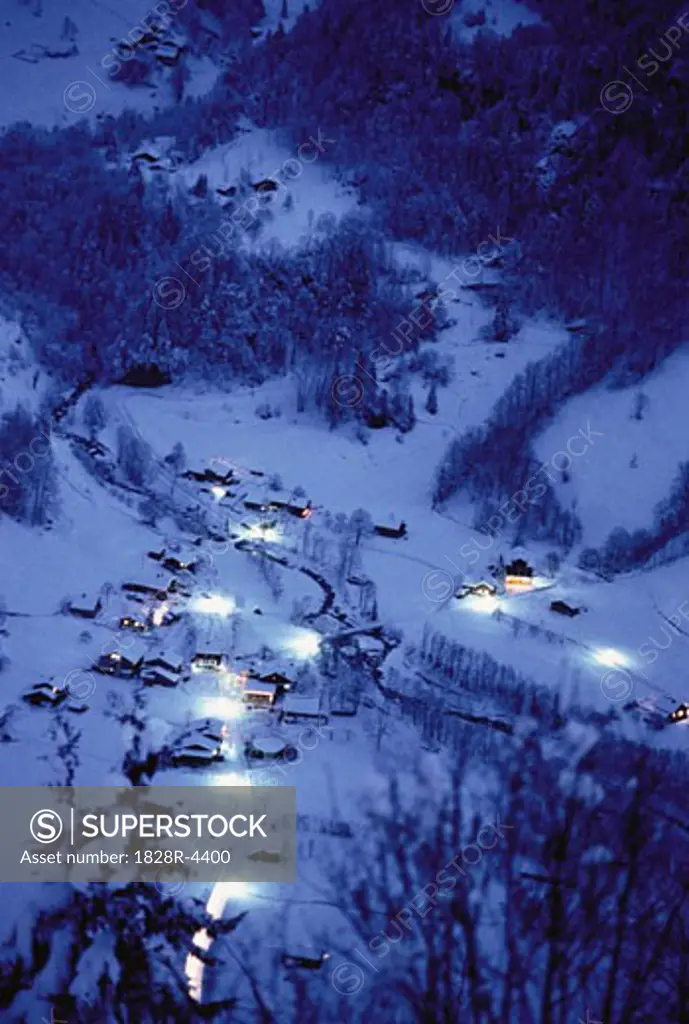 Overveiw of Houses and Trees from Mountain at Night in Winter Switzerland   
