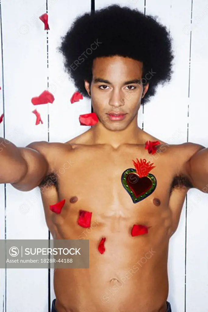 Rose Petals Falling on Man With Heart on Chest   
