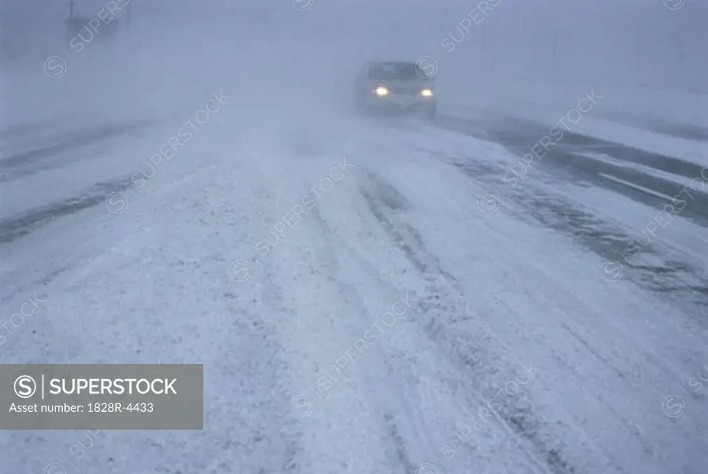 Car on Road in Snow Storm, Ottawa, Ontario, Canada   