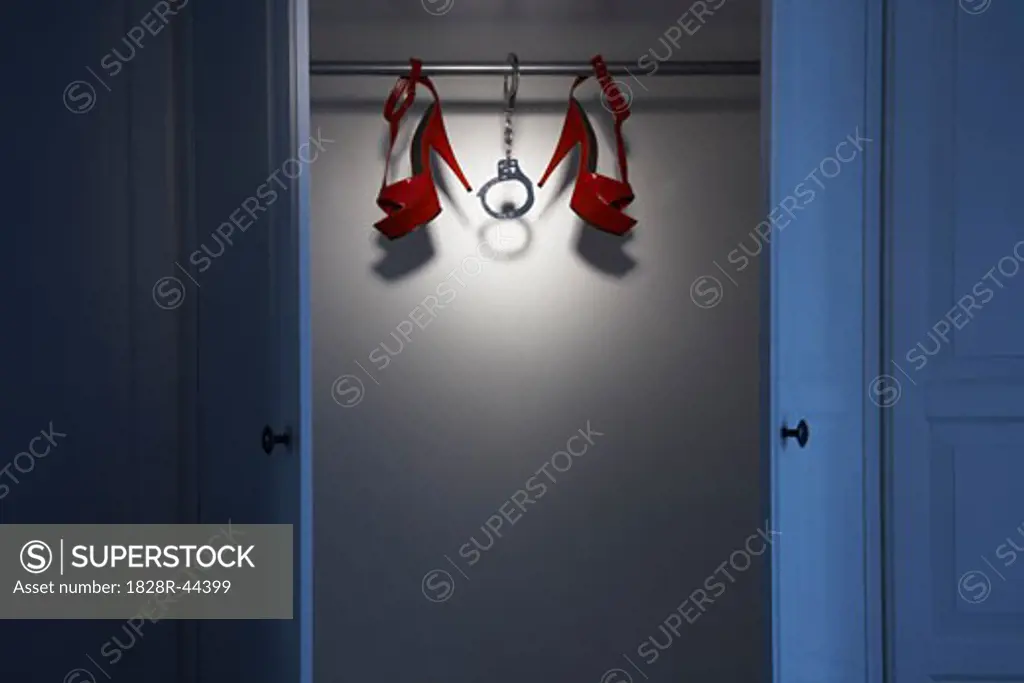 Still Life of Red Shoes and Handcuffs in Closet   