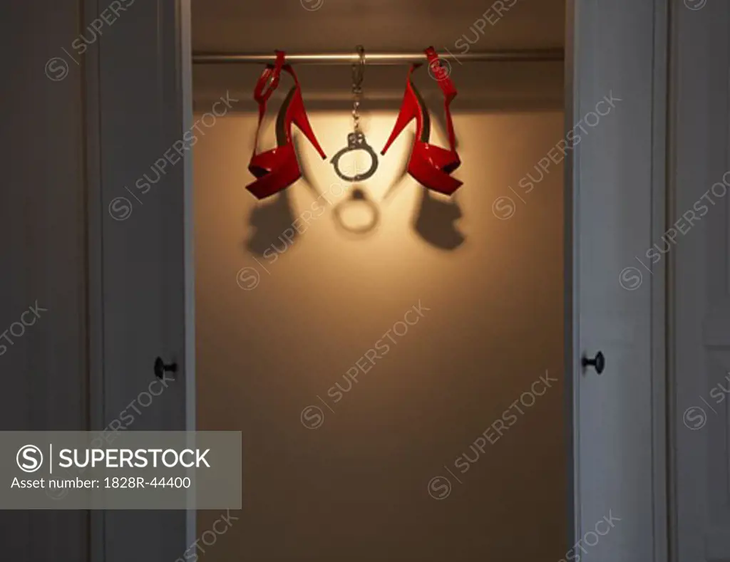 Still Life of Red Shoes and Handcuffs in Closet   