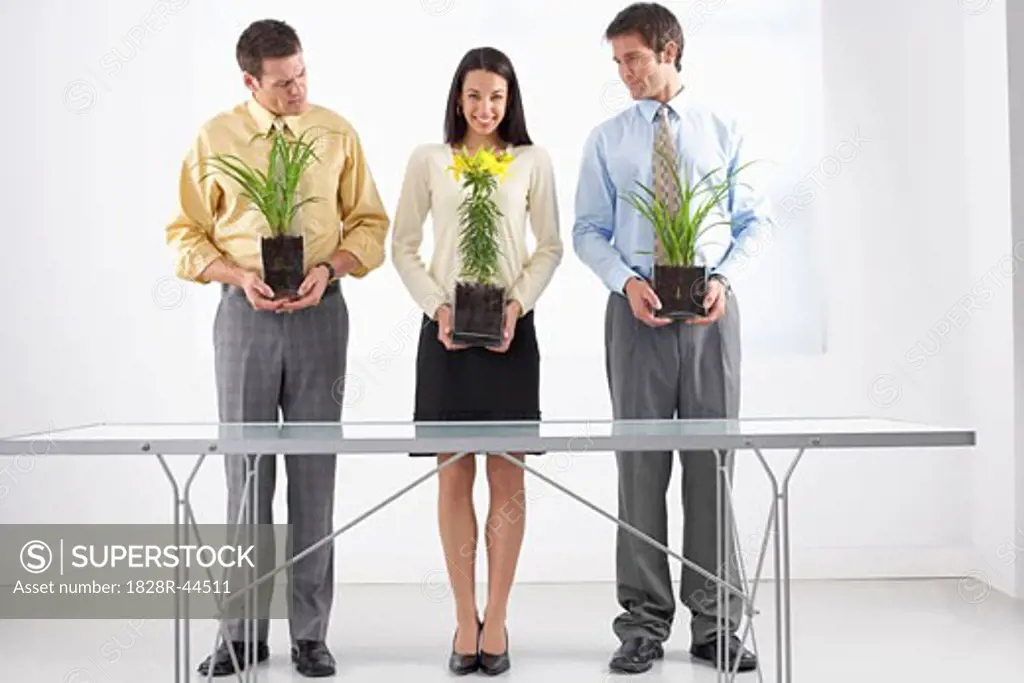 Businesspeople Holding Plants   