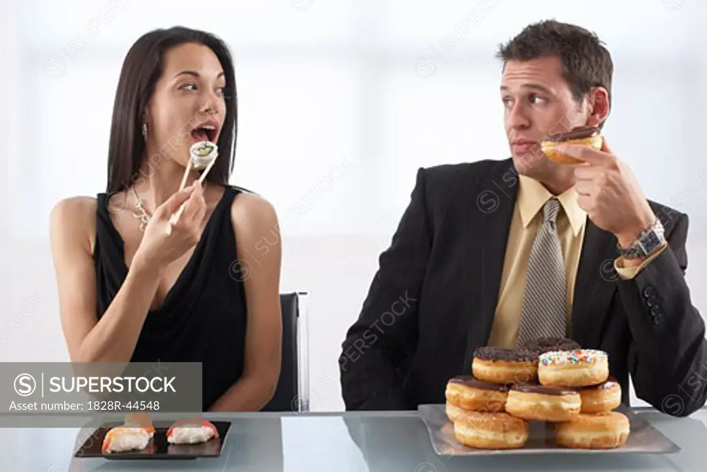 Woman Eating Sushi and Man Eating Doughnuts   