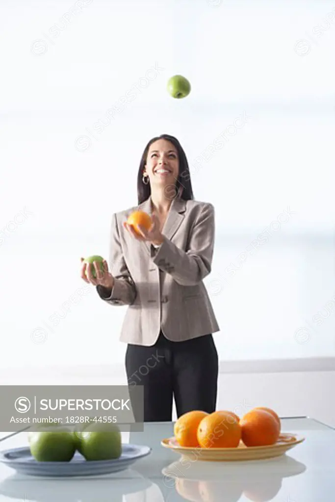 Businesswoman Juggling Apples and Oranges   