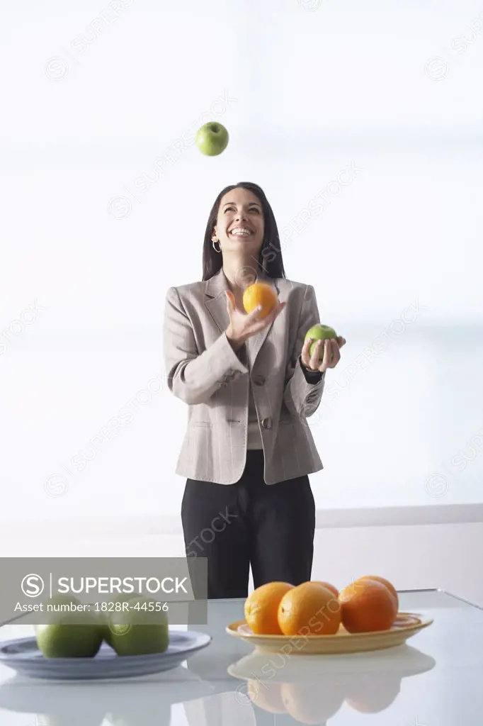Businesswoman Juggling Apples and Oranges   