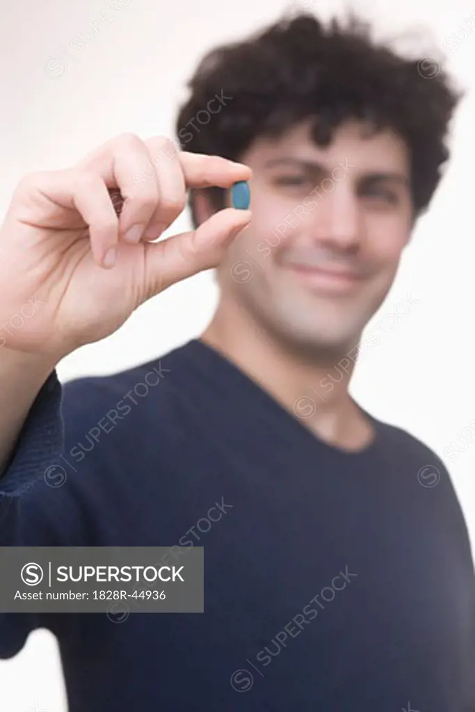 Man Holding Pill   