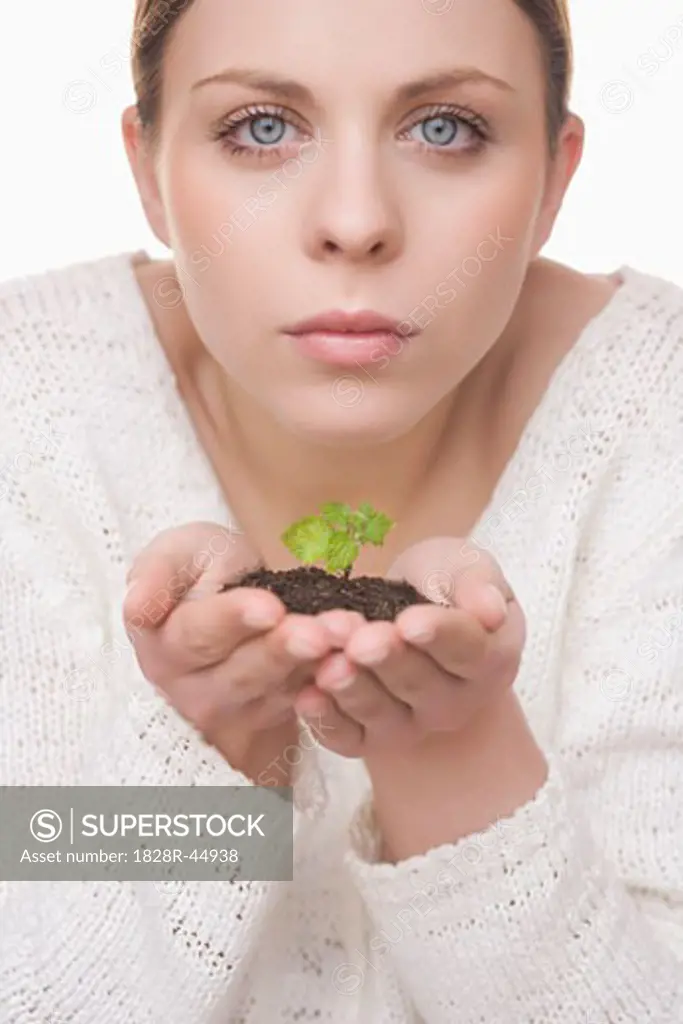 Woman Holding Plant in Soil   