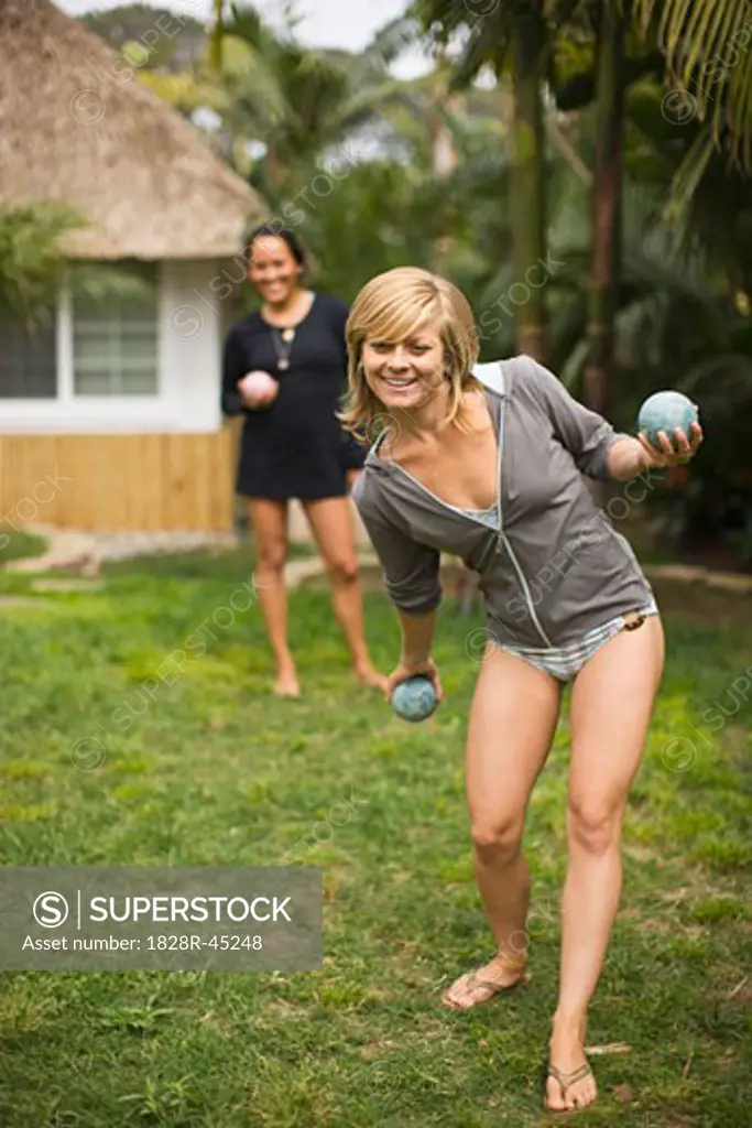 Women Playing Bocce Ball in Yard   