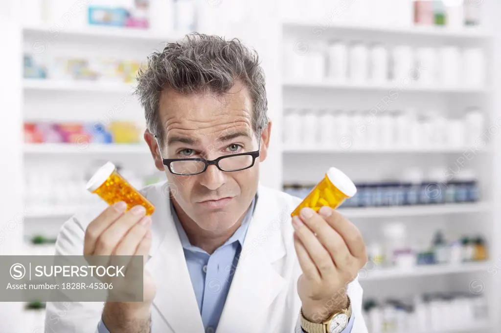 Portrait of Pharmacist Holding Pill Bottles   