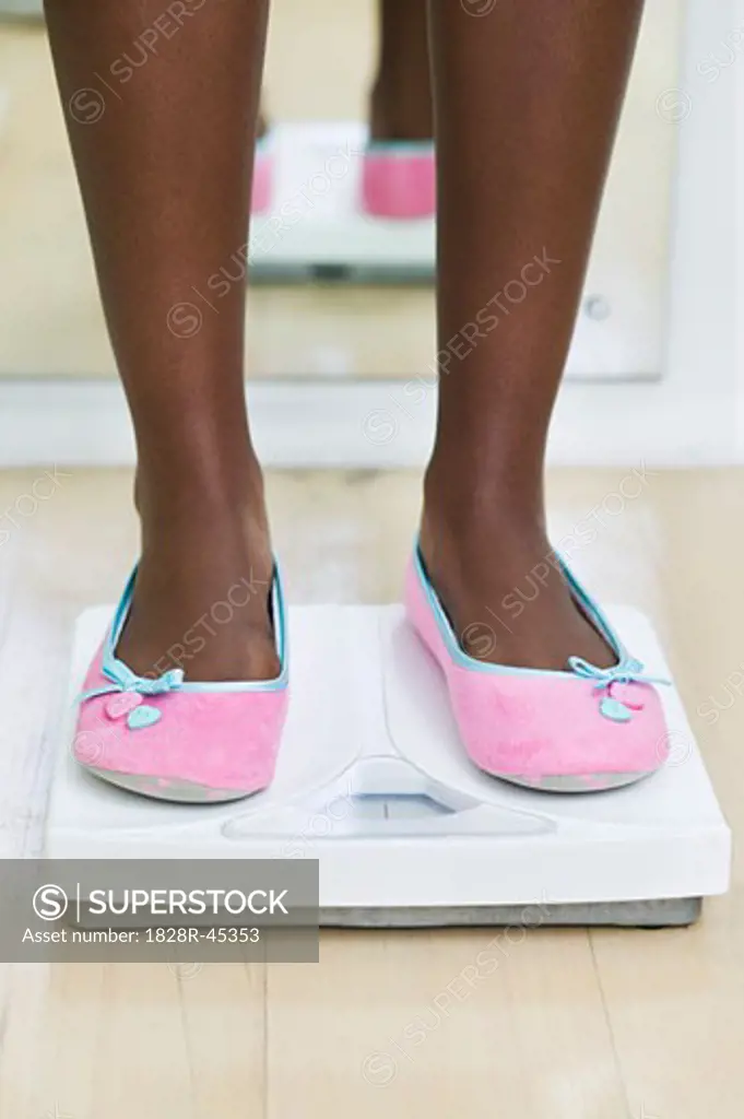 Woman's Feet on Bathroom Scale   
