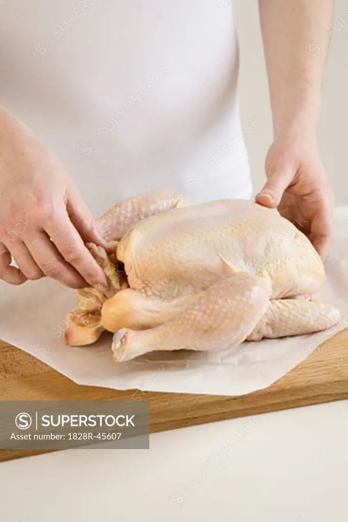 Woman Preparing Chicken for Roasting   