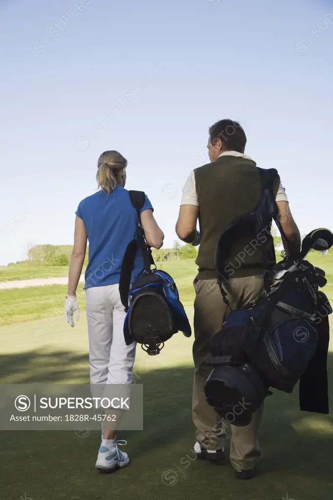 Couple Walking on Golf Course   