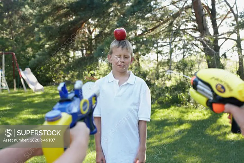 Kids Shooting Water Pistols at Apple on Boy's Head, Elmvale, Ontario, Canada   