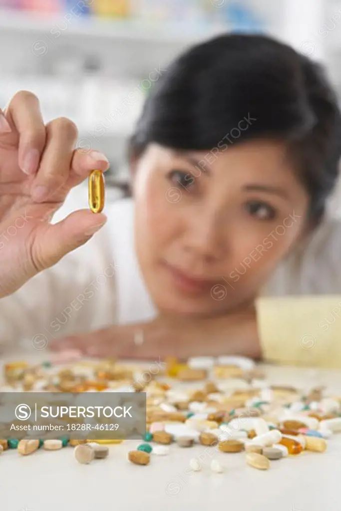 Portrait of Pharmacist Looking at a Pill   