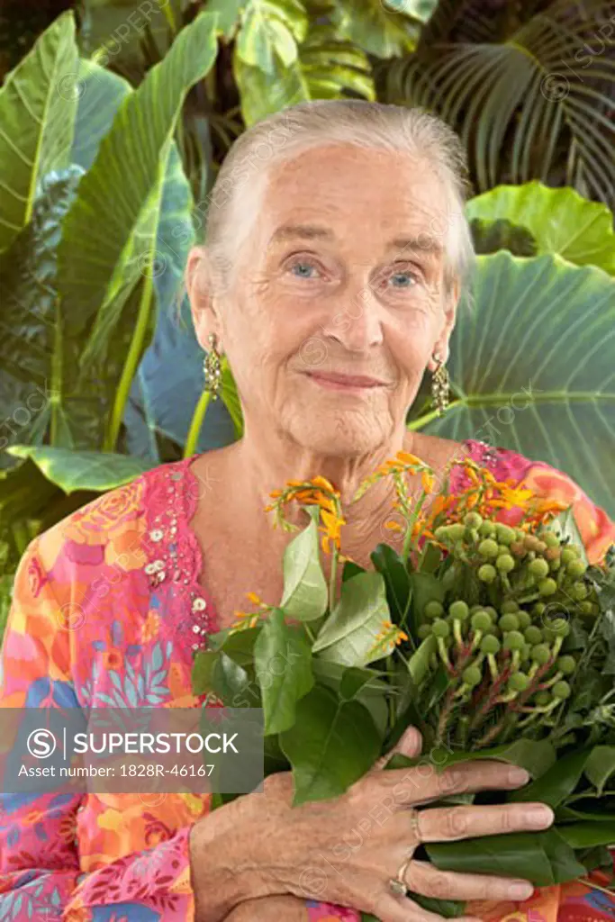 Portrait of Mature Woman Holding Plant   