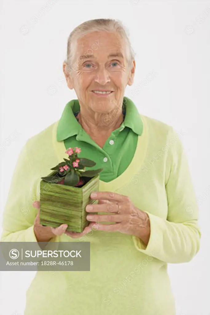 Portrait of Woman Holding Potted Plant   