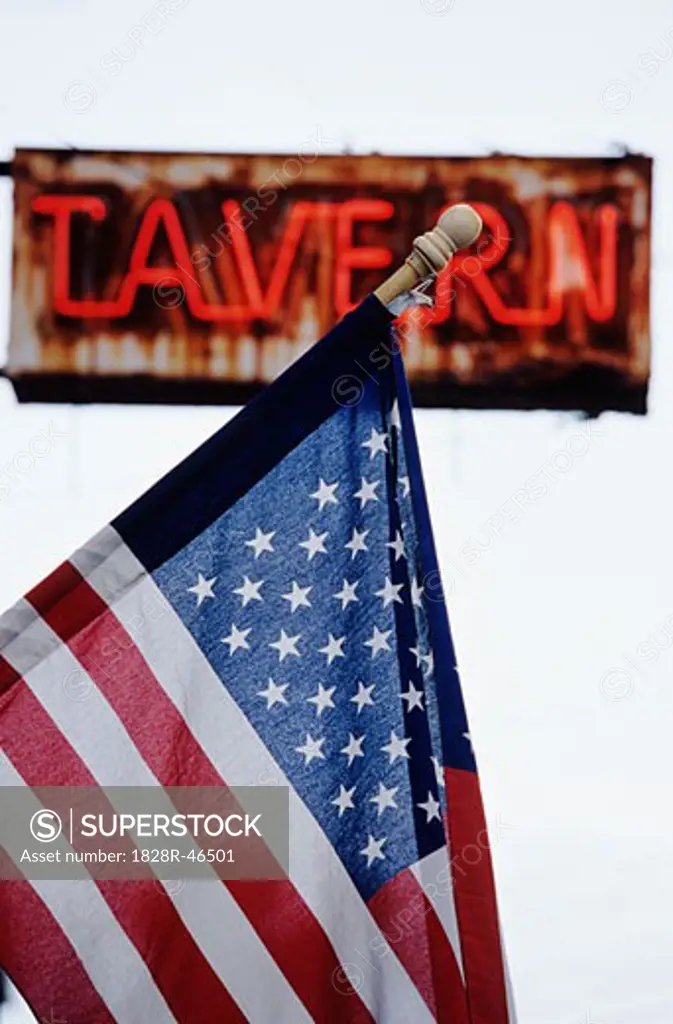 American Flag in Front of Tavern Sign   