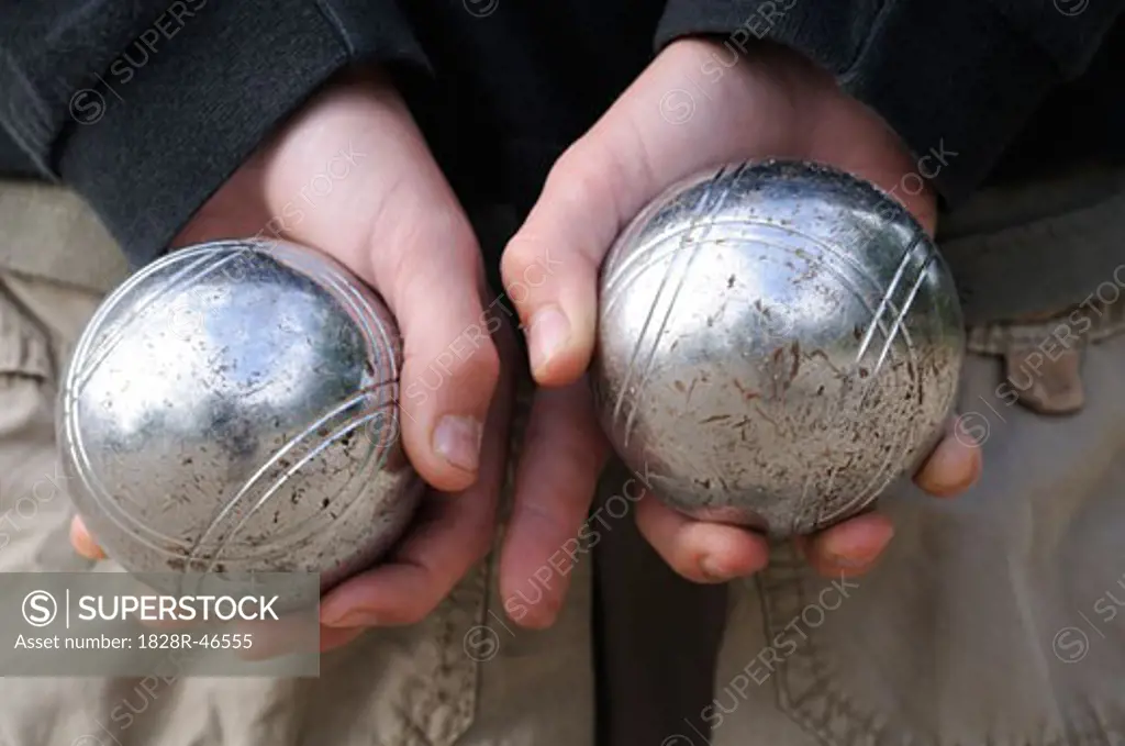 Boy's Hands Holding Petanque Balls   
