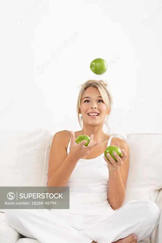 Young Woman Juggling Apples   