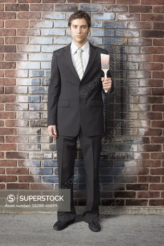 Businessman with Paintbrush by Brick Wall Painting   