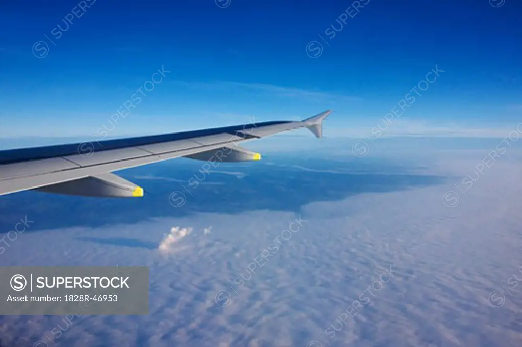 Airplane Flying Above Clouds   