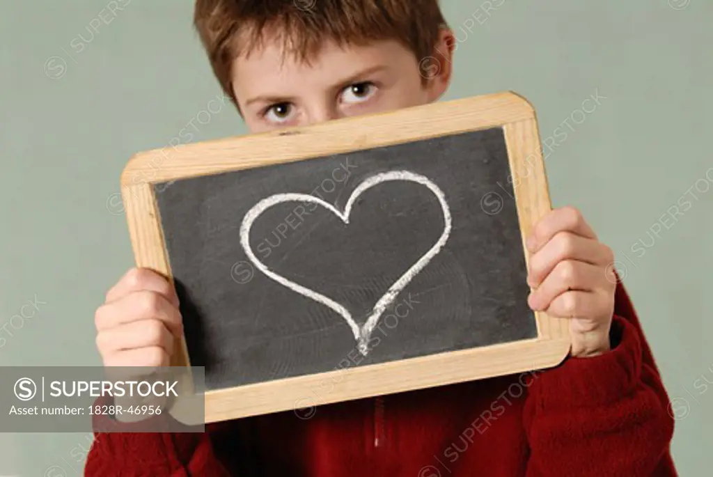 Boy Holding Chalkboard with Heart Drawn on It   
