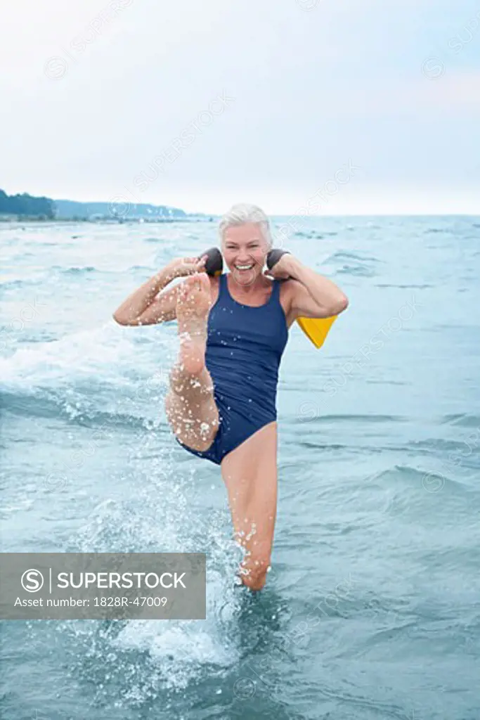 Woman Splashing in Shallow Water   