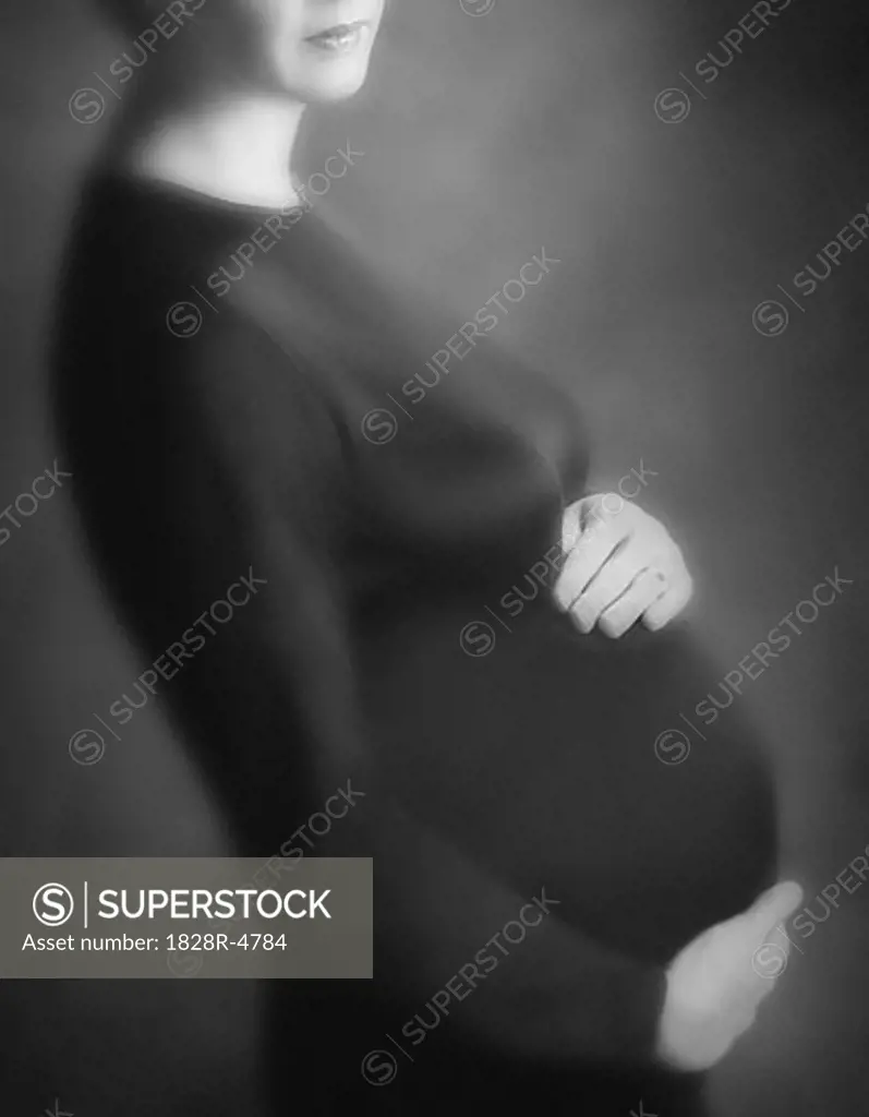 Profile of Pregnant Woman Holding Stomach   