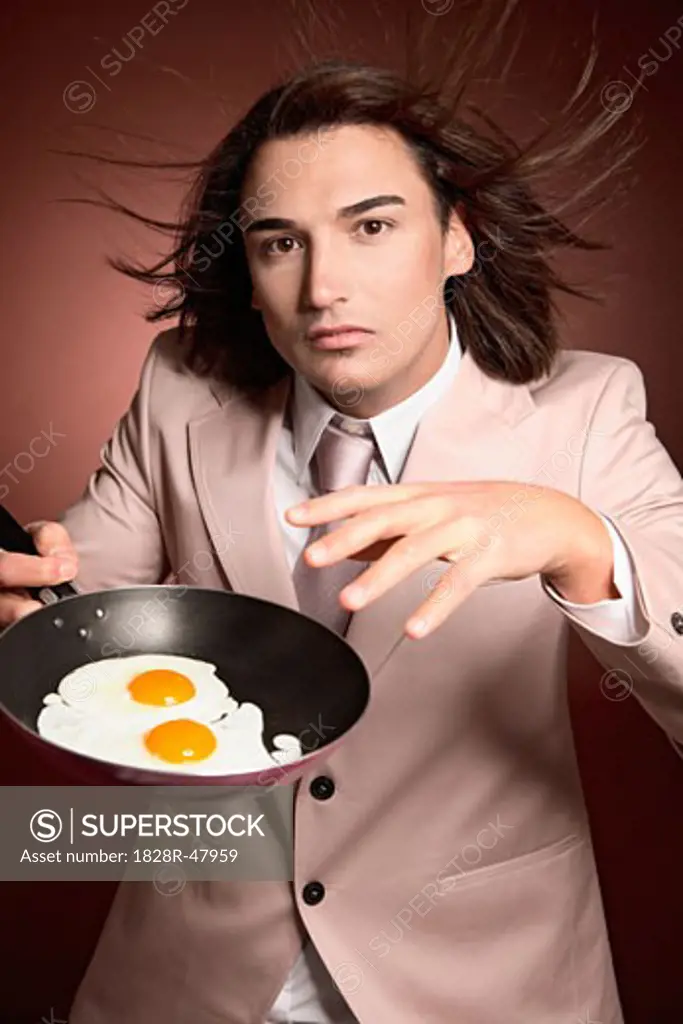 Man Holding Frying Pan with Eggs   