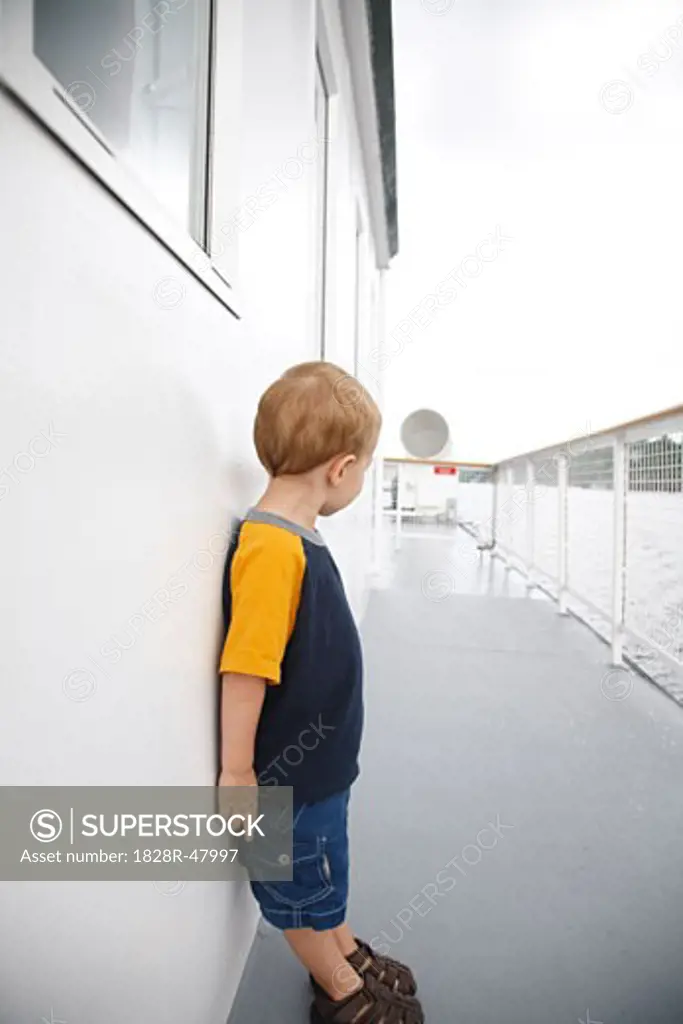 Boy Standing on Deck of Ship   