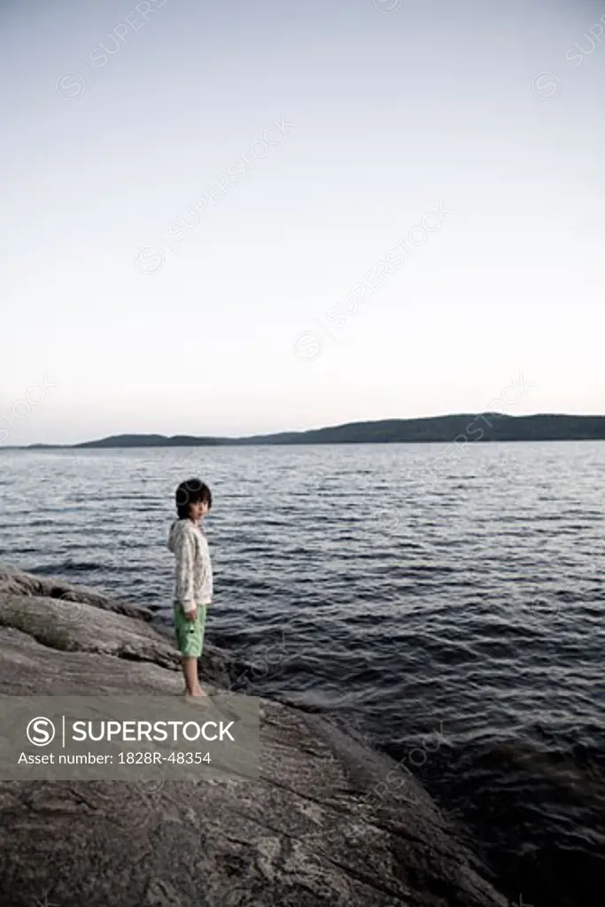 Boy on Rocky Shoreline, Sandbanks Provincial Park, Prince Edward County, Ontario   