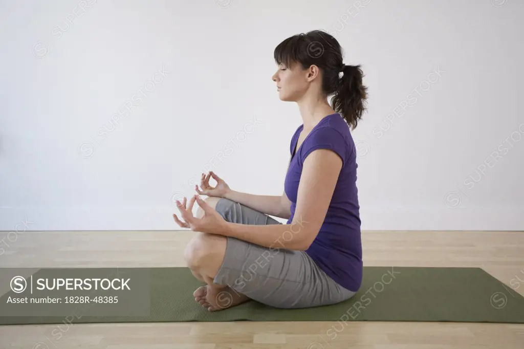 Woman Meditating in Lotus Pose   