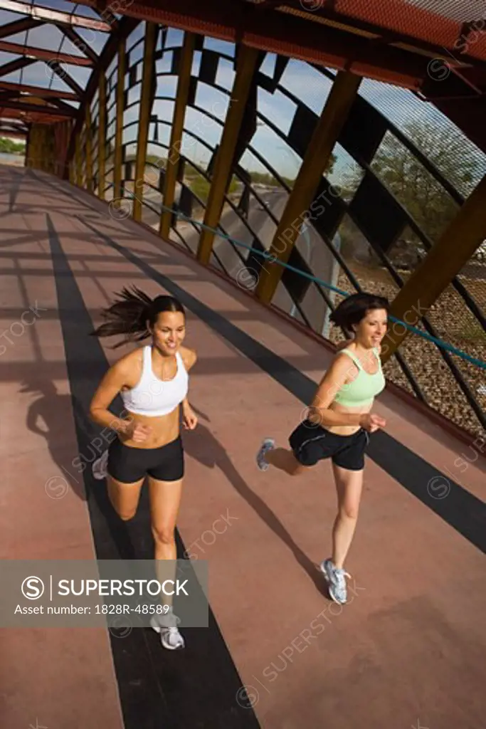 Two Women Running Across a Pedestrian Bridge, Tucson, Arizona, USA   